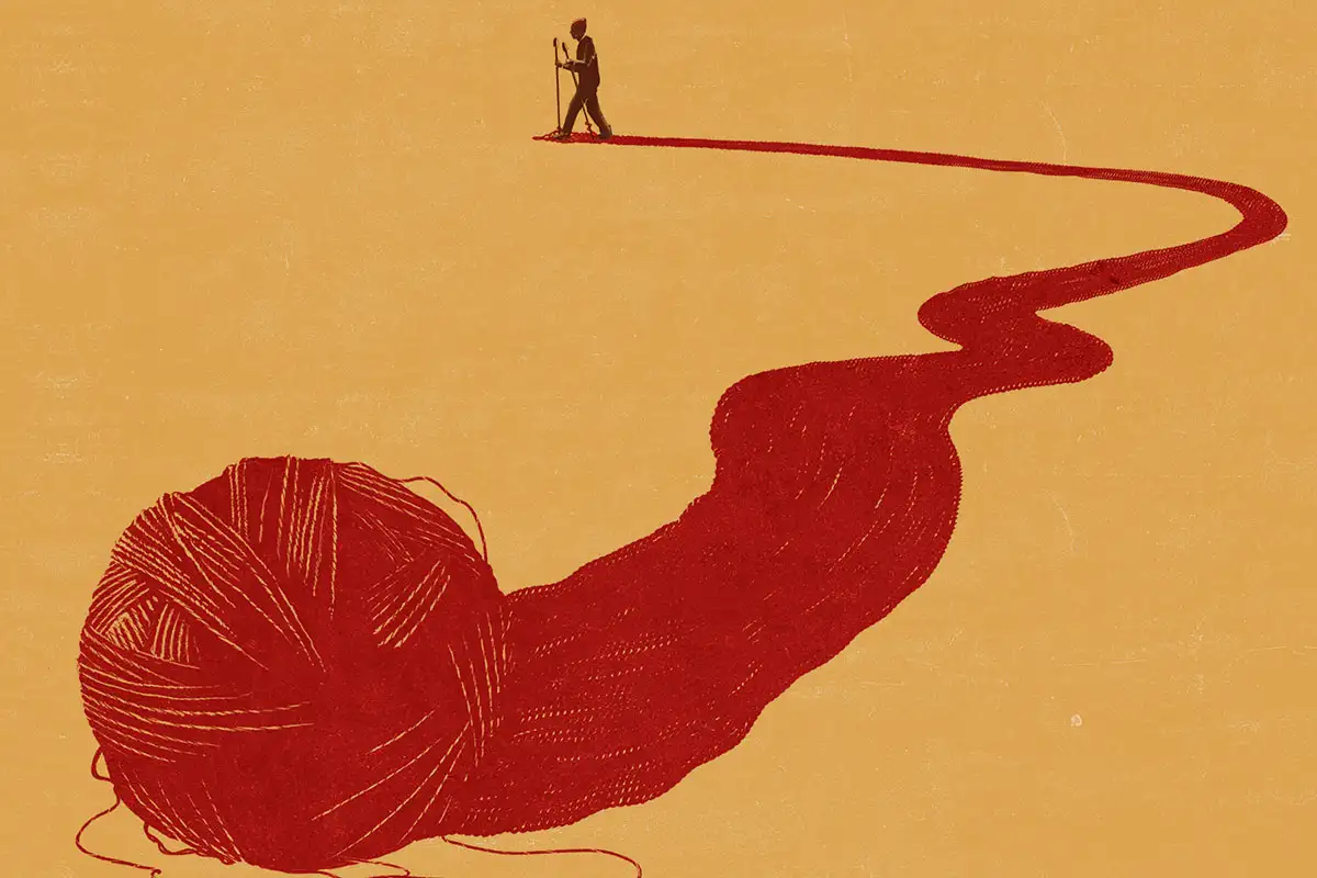 مرد در انتهای کاموای قرمز باز شده